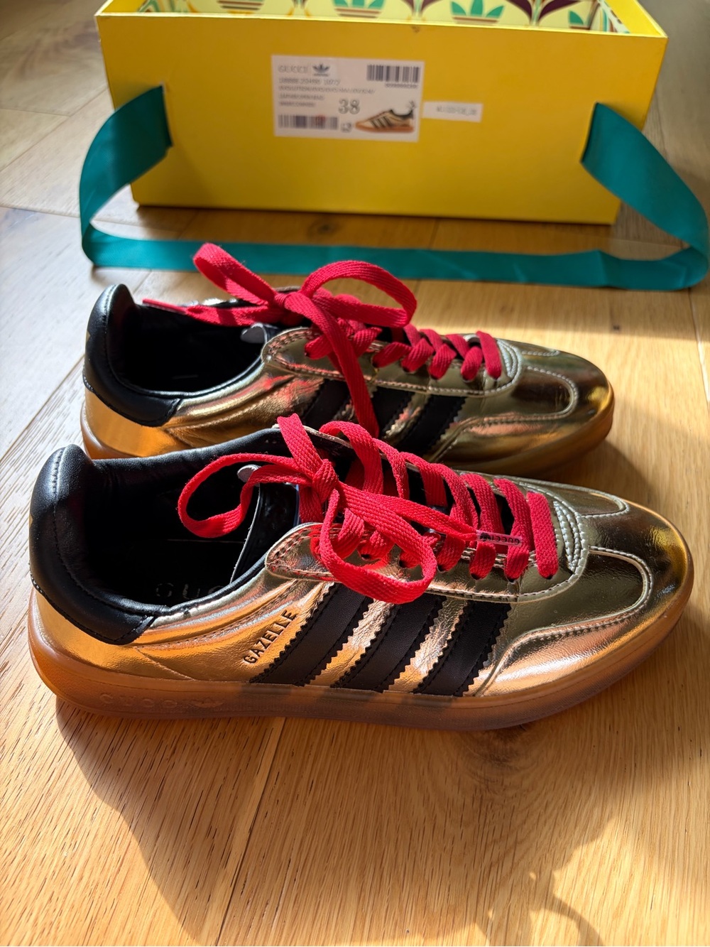 Gucci x Adidas Gazelle Metallic Gold Sneakers with Black Stripes and Red Laces